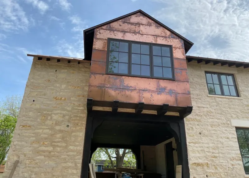 Copper metal panel facade on a stone building for Roof Repair in Nogales